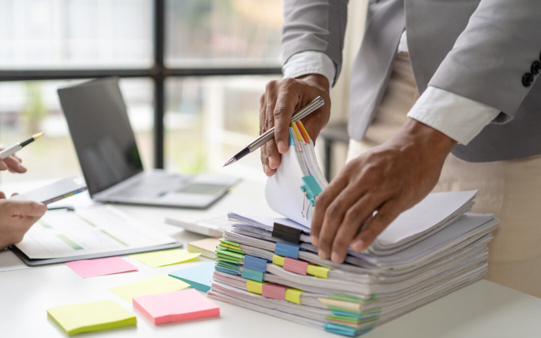 IP attorney working in stacks of paperwork and contracts