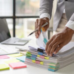 IP attorney working in stacks of paperwork and contracts