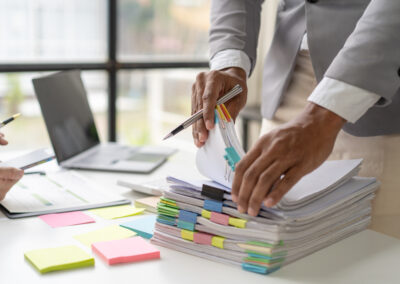 IP attorney working in stacks of paperwork and contracts