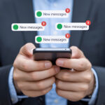 Attorney checking smartphone with multiple new messages notifications.