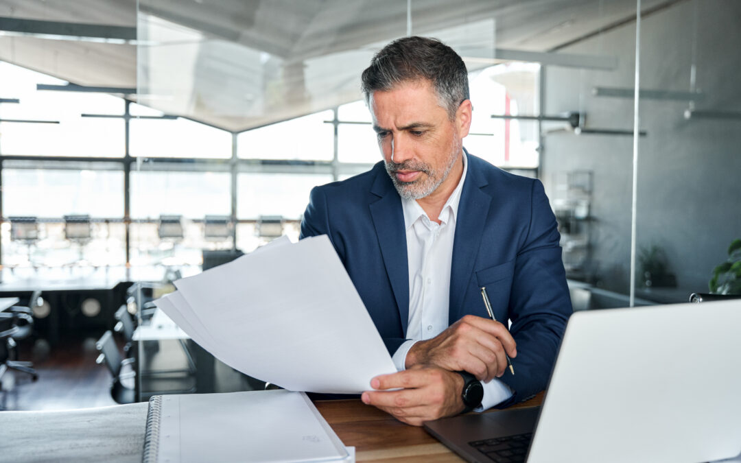 Litigation attorneys working in stacks of papers searching for information.