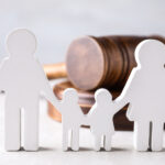 Family law figures in the shape of people and wooden gavel.