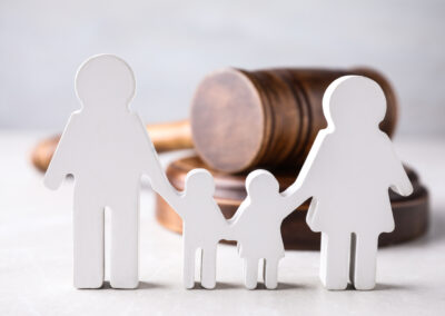 Family law figures in the shape of people and wooden gavel.