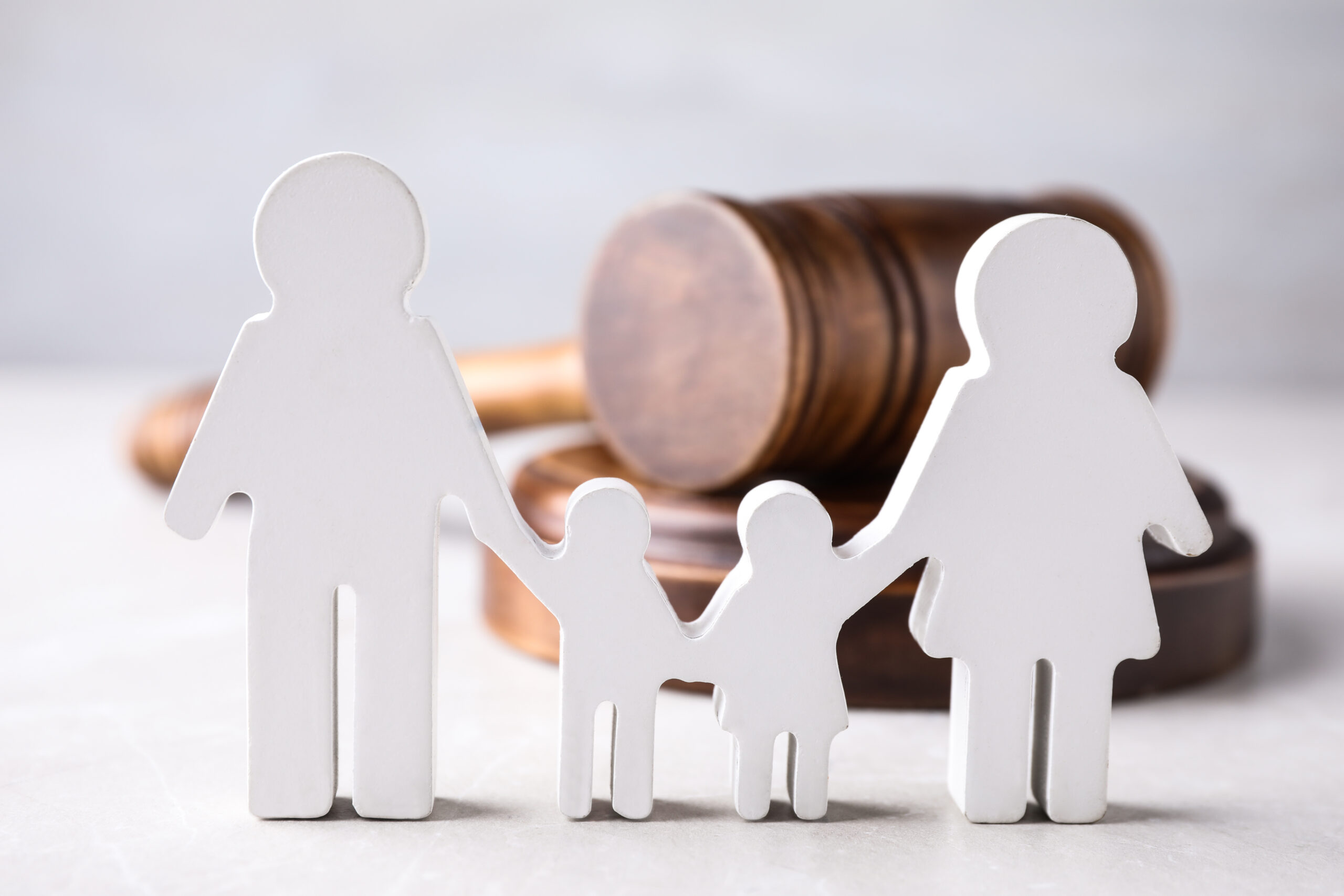 Family law figures in the shape of people and wooden gavel.