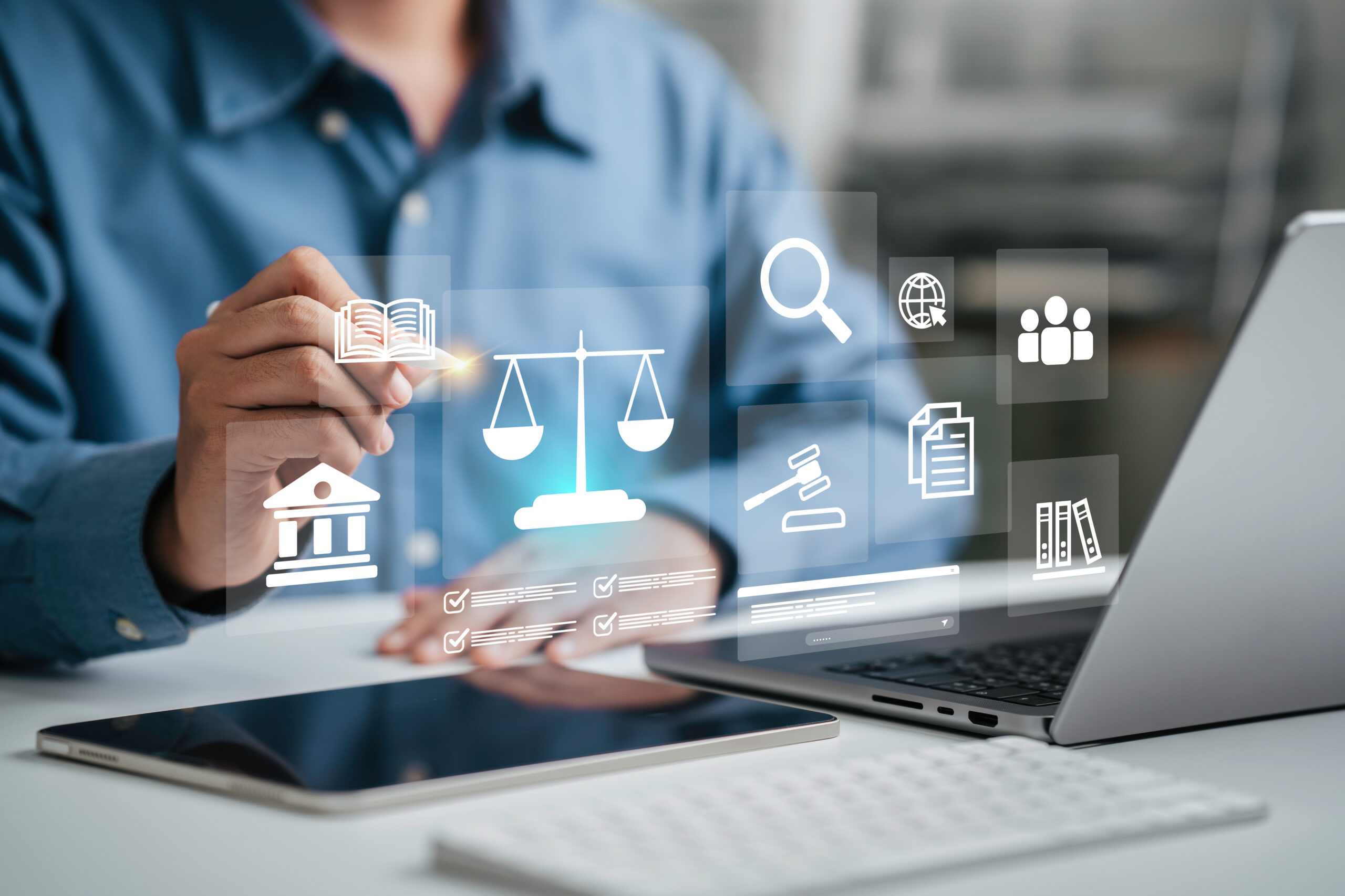 Attorney working on a large discovery project, using a laptop with a legal services icon.