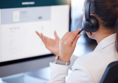 Legal intake receptionist wearing headset talking to client.
