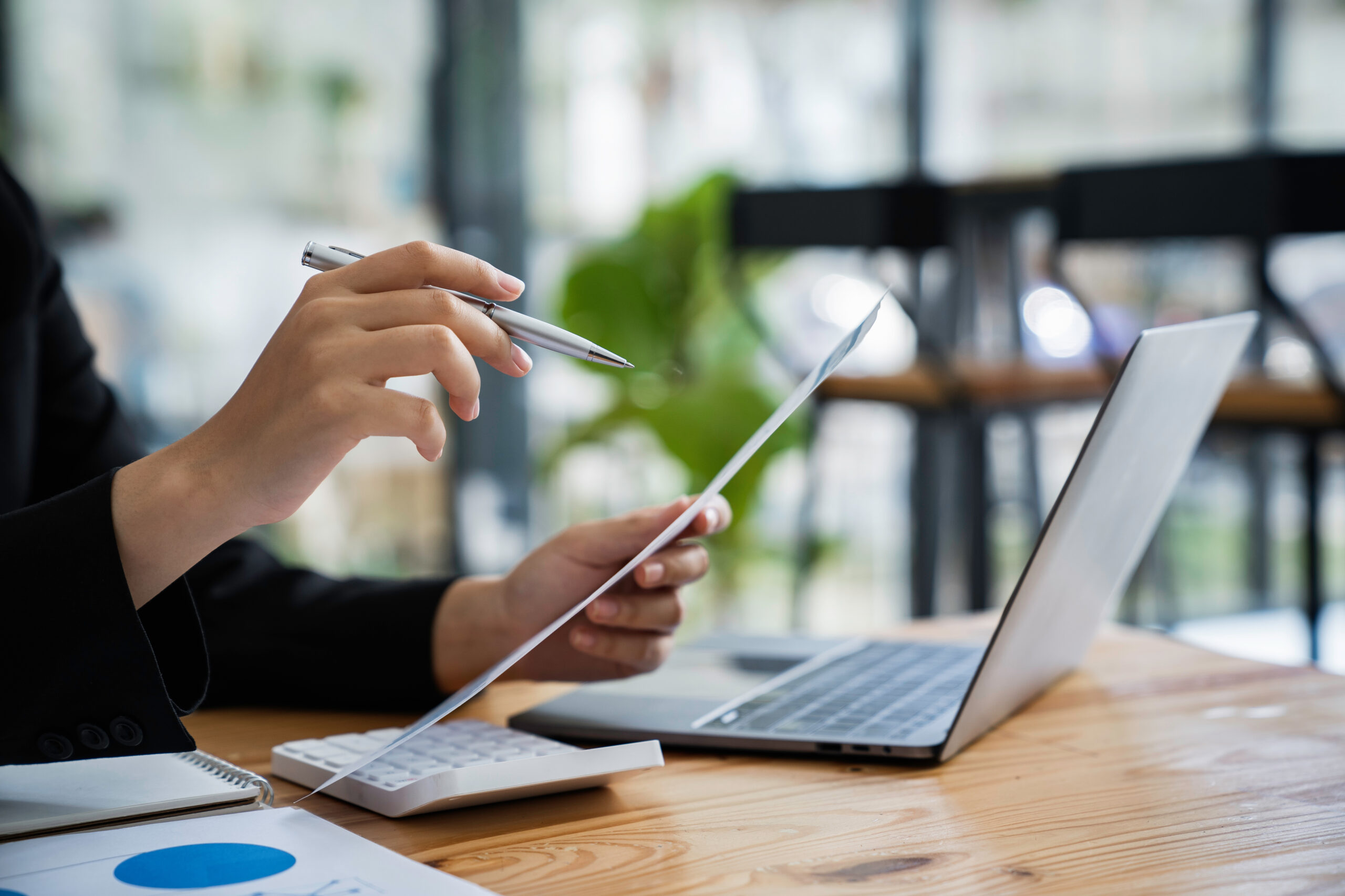 cropped shot view of a bookkeeper or financial inspector hands making a report, calculating or checking balance. Home finances, investment, economy concept virtual executive assistant for nonprofit